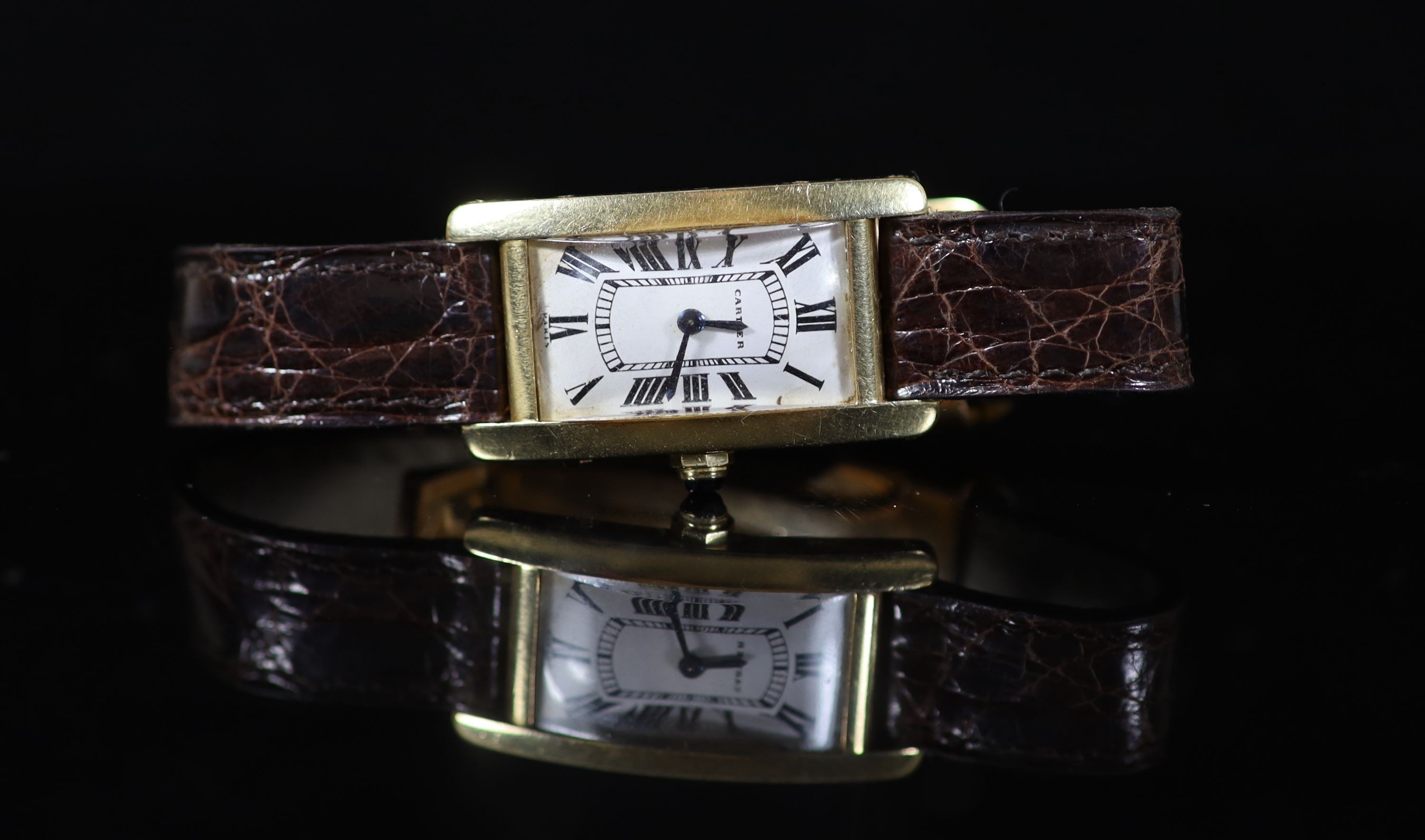 A lady's French 18ct gold Cartier Tank Americaine manual wind wrist watch, on a gold mounted Cartier leather strap, with deployment clasp